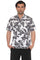 Front view of a man wearing the white Menâ€™s Textured Seersucker Resort Shirt with a black festive print.