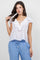 A woman models the white Ladies Casual Boho Ruffled Tie Blouse with blue pants.