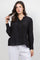 A woman models the Ladies Boho Lace Panel Pleated Long Sleeve Blouse in black with lace detail down the front.