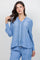 Woman models the light blue Ladies Boho Lace Panel Pleated Long Sleeve Blouse and matching pants.
