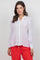 Front view of a woman wearing a white Ladies Boho Lace Panel Pleated Long Sleeve Blouse with lace detail.