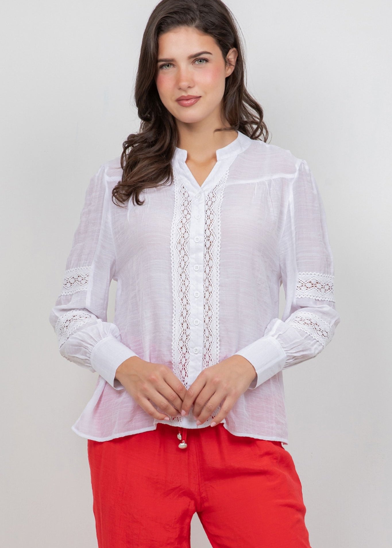 A woman models the Ladies Boho Lace Panel Pleated Long Sleeve Blouse, showing the lace detail and mandarin collar.