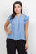 Front view of a woman wearing a light blue Ladies Boho Flutter Sleeve Button Blouse with crochet trim and black pants.