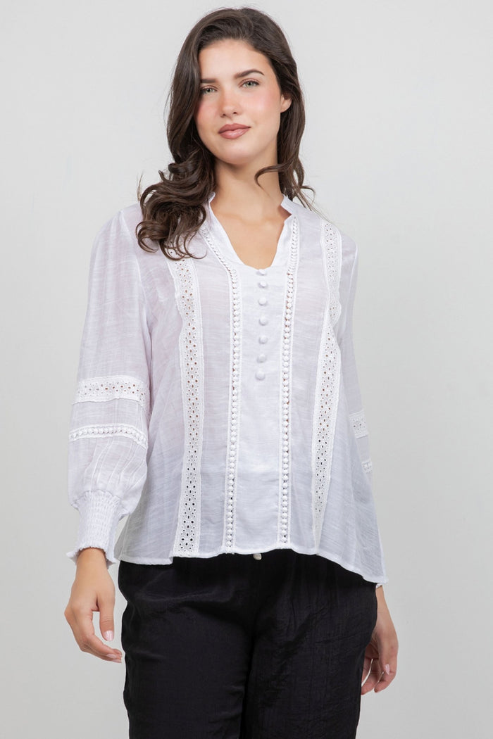 Front view of a woman wearing a white, button-down Ladies Boho Lace Panel Long Sleeve Blouse.