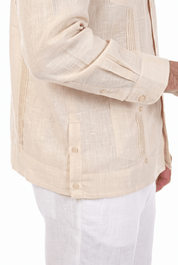 Close-up of a natural beige long-sleeve Irish Linen Four Pocket Guayabera Shirt, showing pocket and French cuff details.