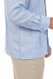 Close-up of a light blue long-sleeve Irish Linen Four Pocket Guayabera Shirt, showing pocket and French cuff details.