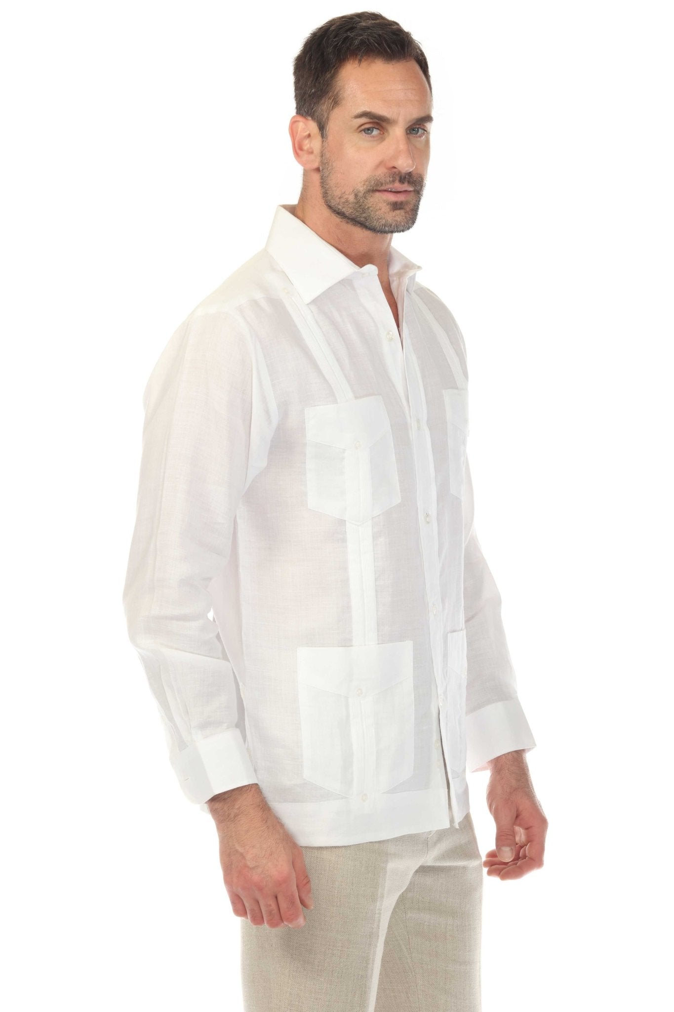 A man models a white, long-sleeved Irish Linen Four Pocket Guayabera Shirt, shown at a slight angle.