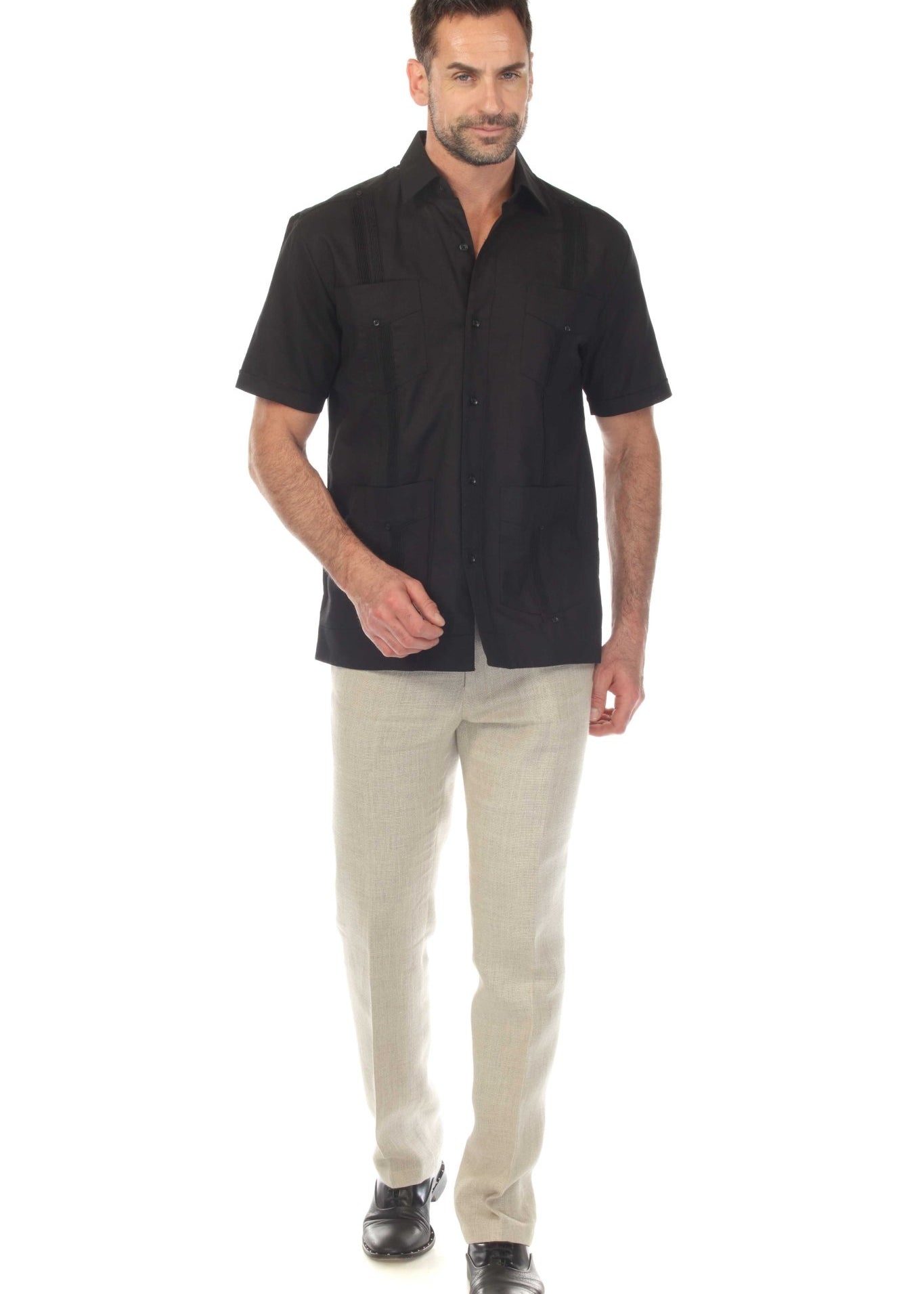 Model wearing a black linen guayabera shirt and light trousers, showcasing a polished outfit for dinner out or special occasions.