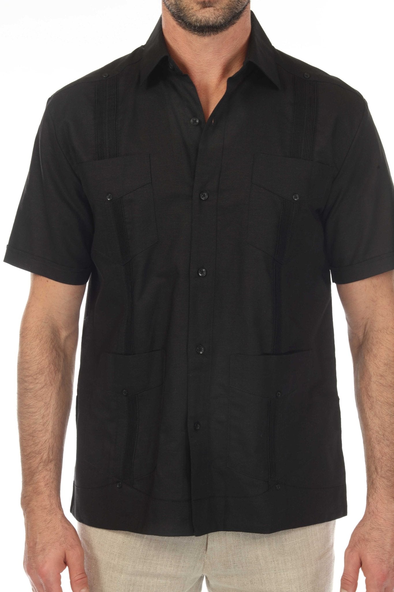 A man wears an open black 100% Linen Classic Short Sleeve Guayabera Shirt, shown from the chest up.