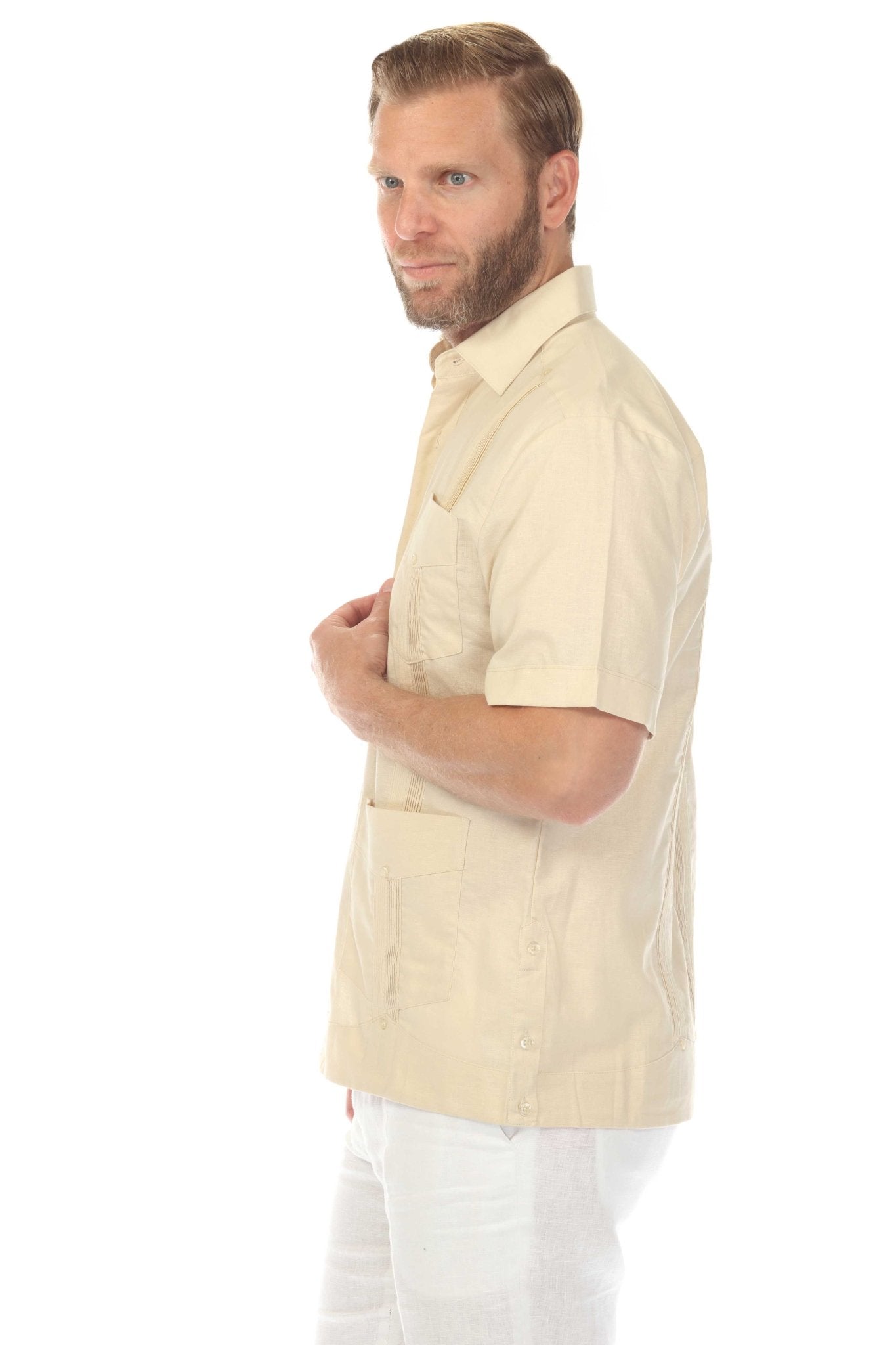 Man in a tan Men's Big & Tall Linen Guayabera Shirt, side view showing pocket and vertical pleat details.