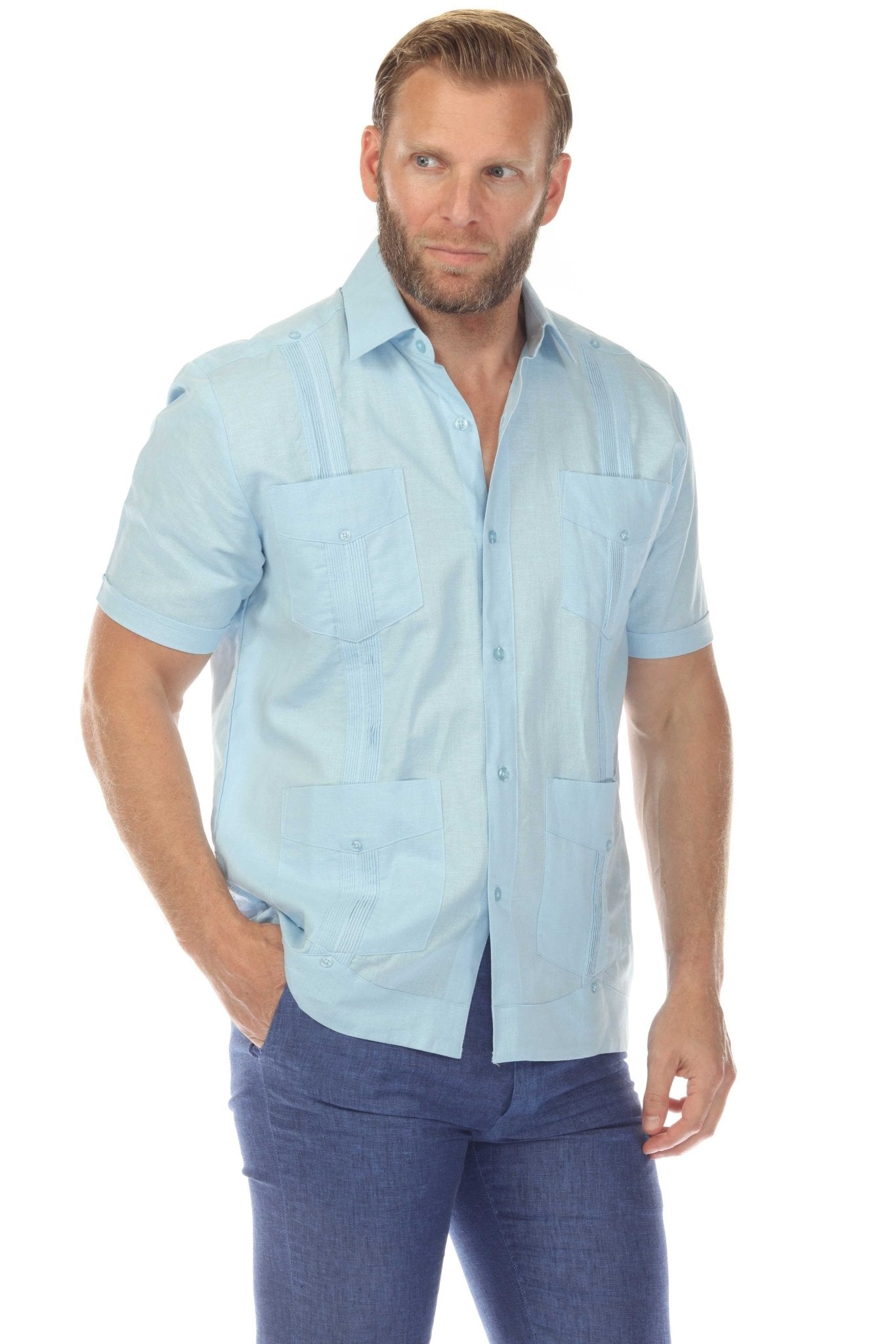 Front view of a man wearing the men’s light blue short sleeve 100% linen guayabera shirt with all four pockets and vertical pleats visible.