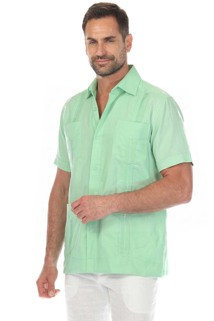Front view of a men's white short sleeve linen guayabera shirt with subtle embroidery and functional pockets.