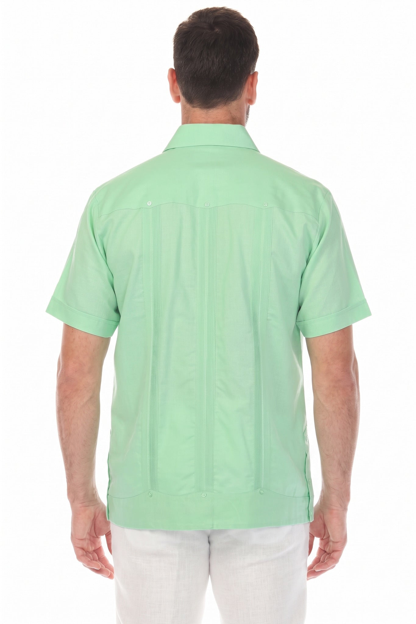 Back view of the mint green linen guayabera shirt highlighting the traditional vertical pleats and relaxed fit.