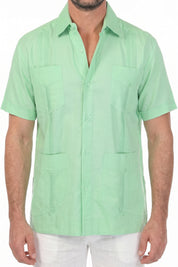 Torso detail of the mint green 100% linen guayabera shirt with four flap pockets and embroidered pleats.