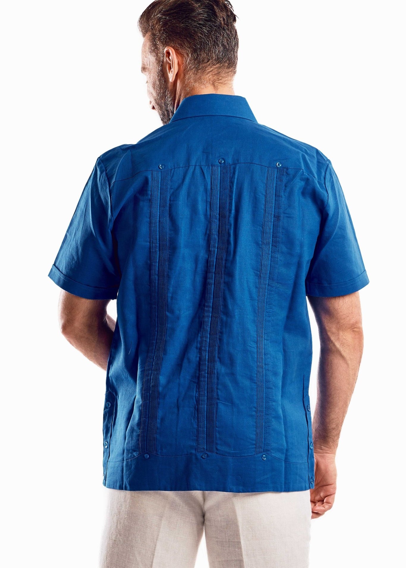 Back view of a short sleeve blue guayabera shirt highlighting the crisp silhouette and breathable linen fabric.