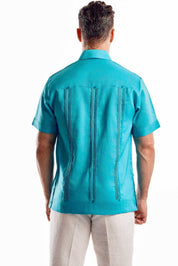 Back view of a turquoise linen guayabera shirt highlighting the traditional vertical pleats and breathable 100% linen texture.