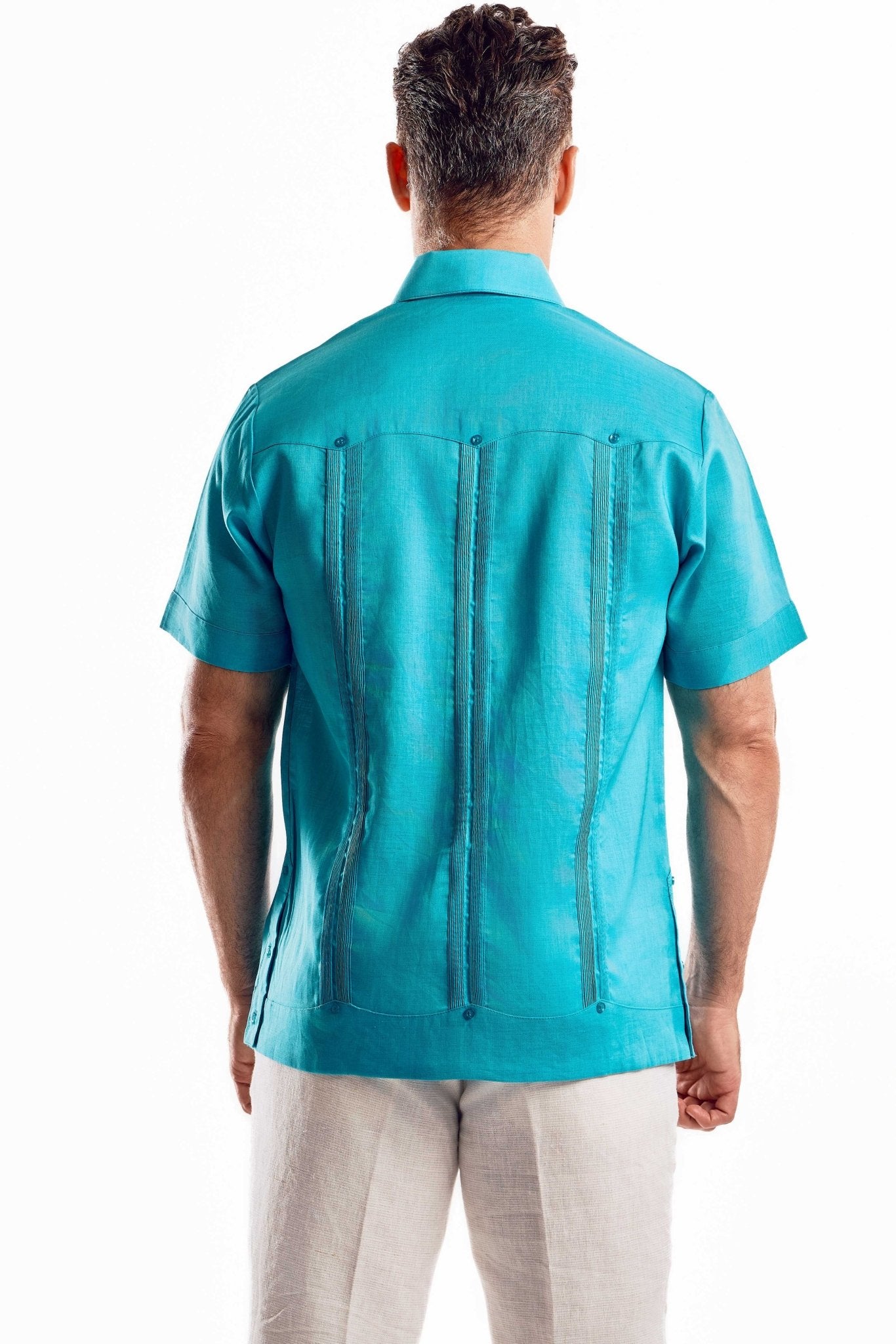 Back view of a turquoise linen guayabera shirt highlighting the traditional vertical pleats and breathable 100% linen texture.