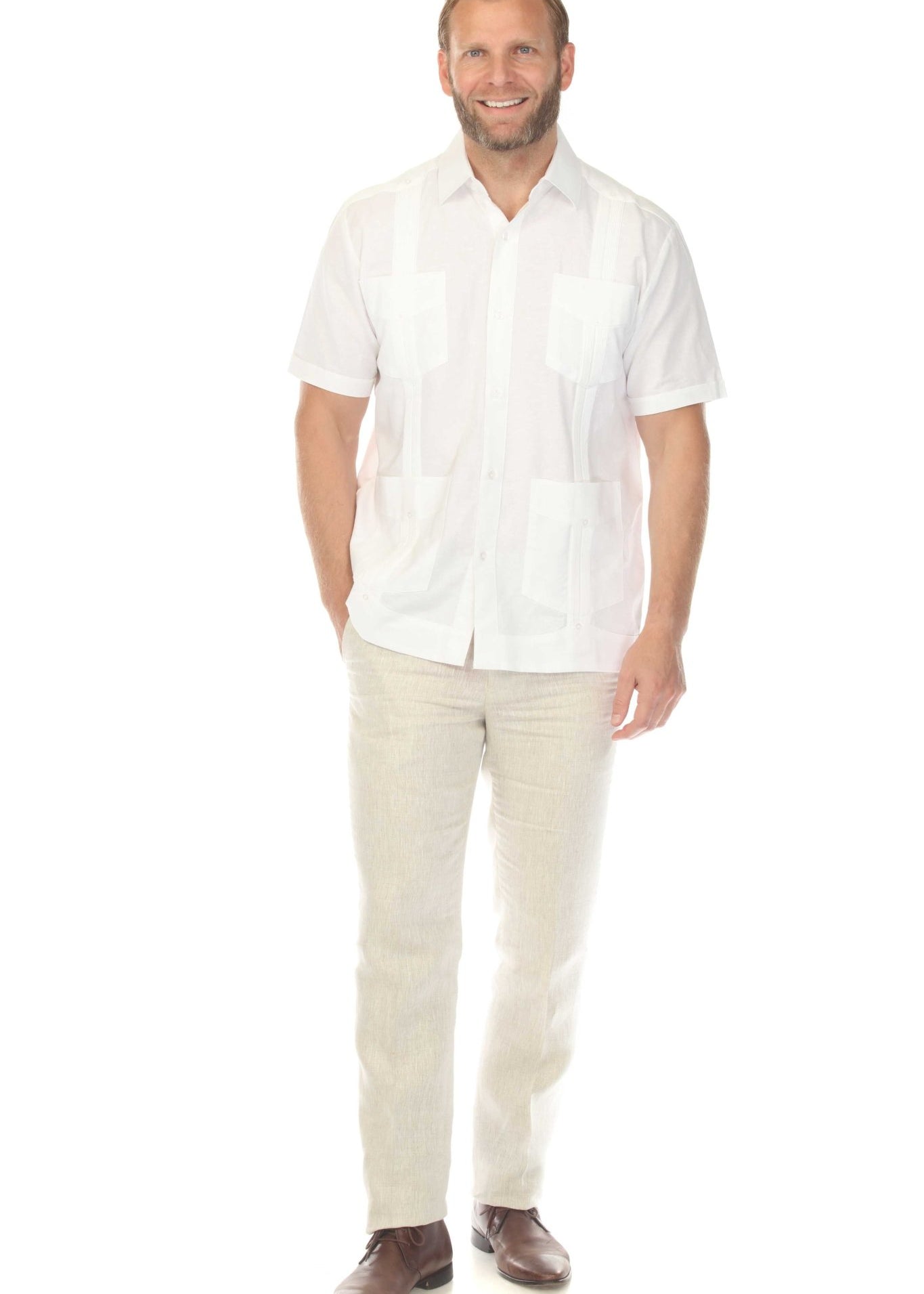Full body shot of a man in a white linen guayabera shirt and tan pants, ideal for a destination wedding or special occasion.