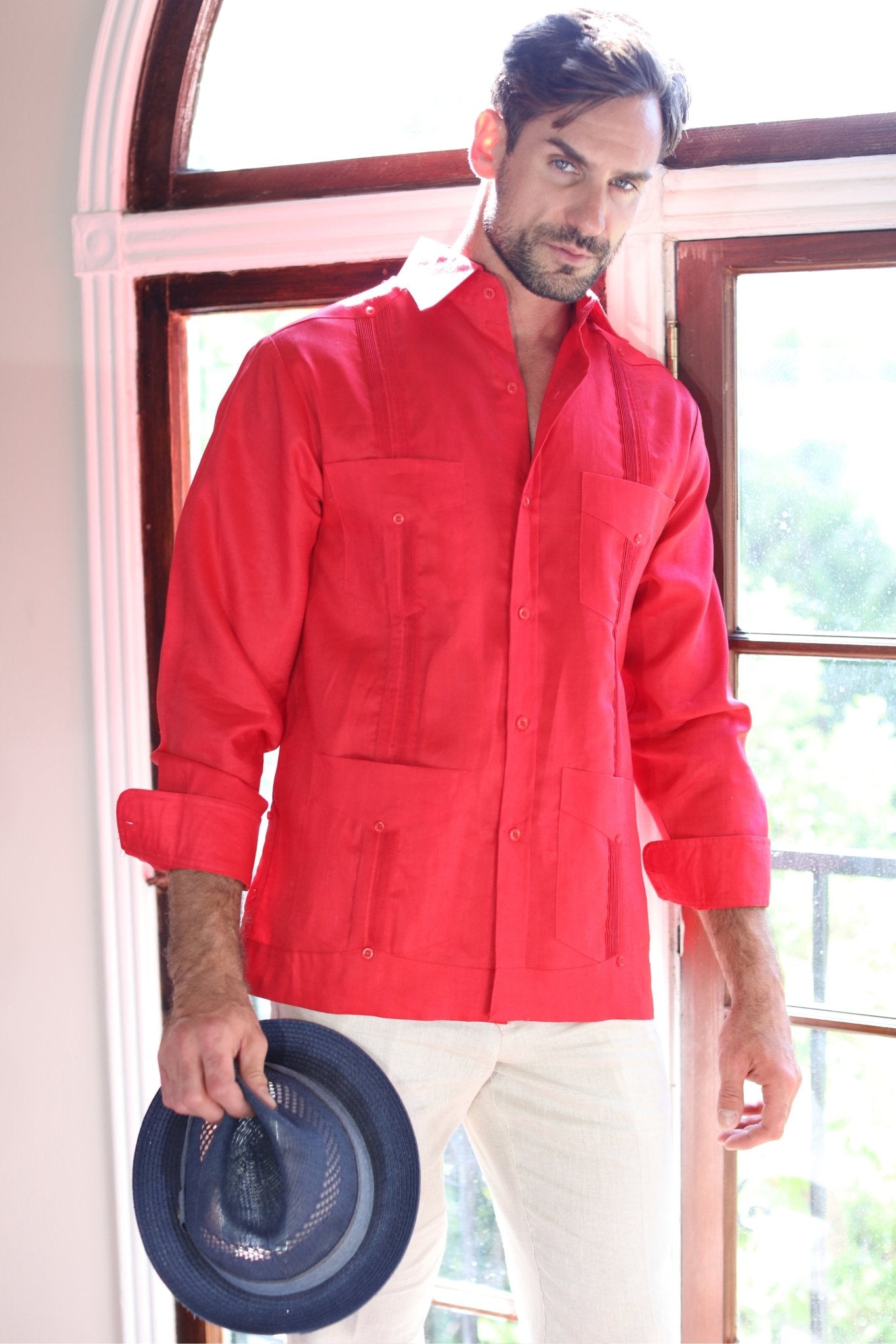 Man in a red Men's Linen Classic Four-Pocket Long Sleeve Guayabera Shirt.