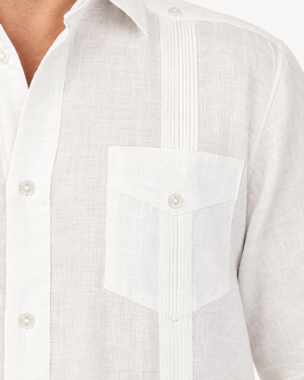 Alforza pin-tucks running through the chest pocket of the white linen guayabera