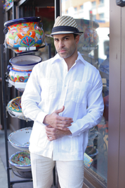 A man models the white Men's Linen Classic Four-Pocket Long Sleeve Guayabera Shirt.