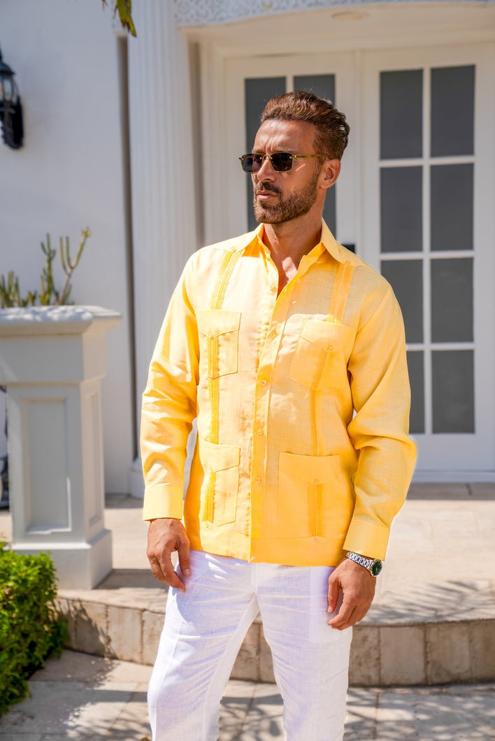 Man wearing a yellow long-sleeve 4-pocket Big & Tall Guayabera shirt, looking left.