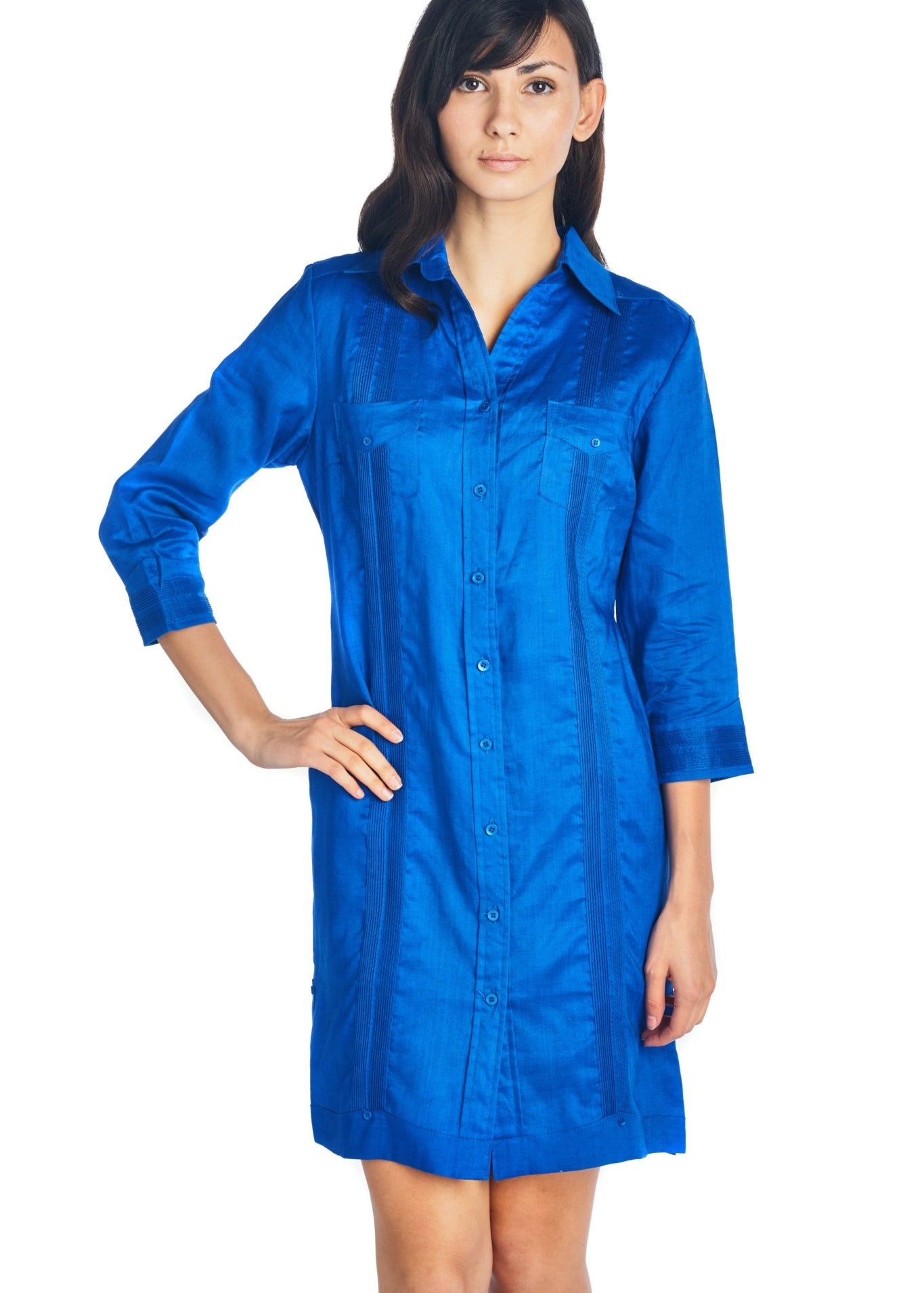 A woman models a front view of a blue, button-down Women's Guayabera Dress Shirt with three-quarter sleeves.