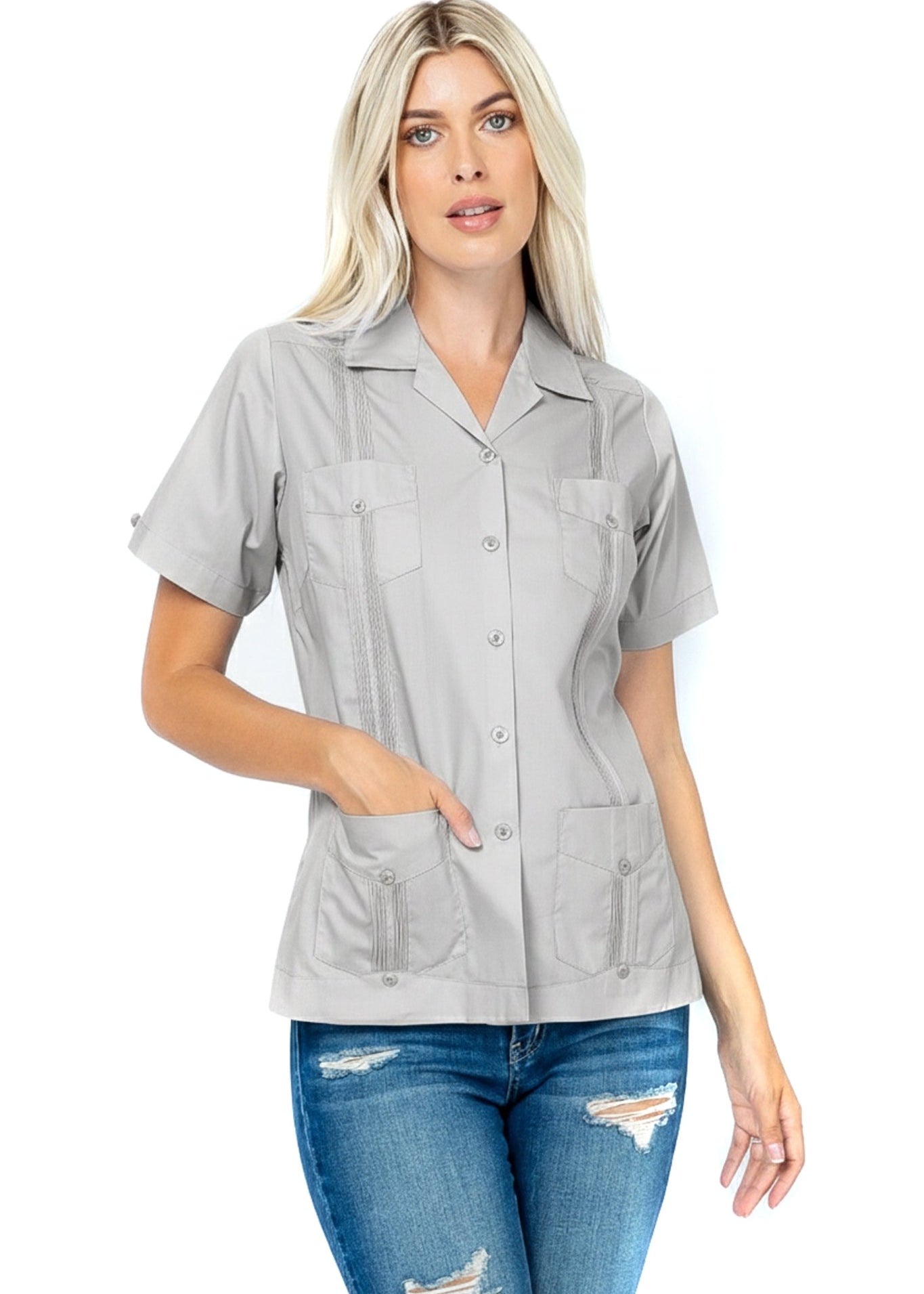 Front view of a woman wearing the grey, short sleeve Women's Guayabera with 4 Pockets, hand in the lower pocket.