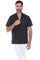 A man wearing a black short sleeve guayabera shirt with white pants, showcasing a sharp and comfortable summer resort style.