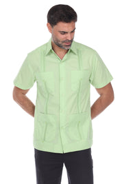 Man wearing a light green short-sleeve guayabera shirt on a white background