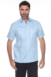 Men’s light blue short sleeve guayabera shirt featuring a traditional 4-pocket layout and breathable cotton-blend fabric.