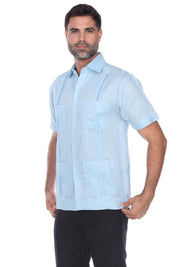 Men’s light blue short sleeve guayabera shirt featuring a traditional 4-pocket layout and breathable cotton-blend fabric.