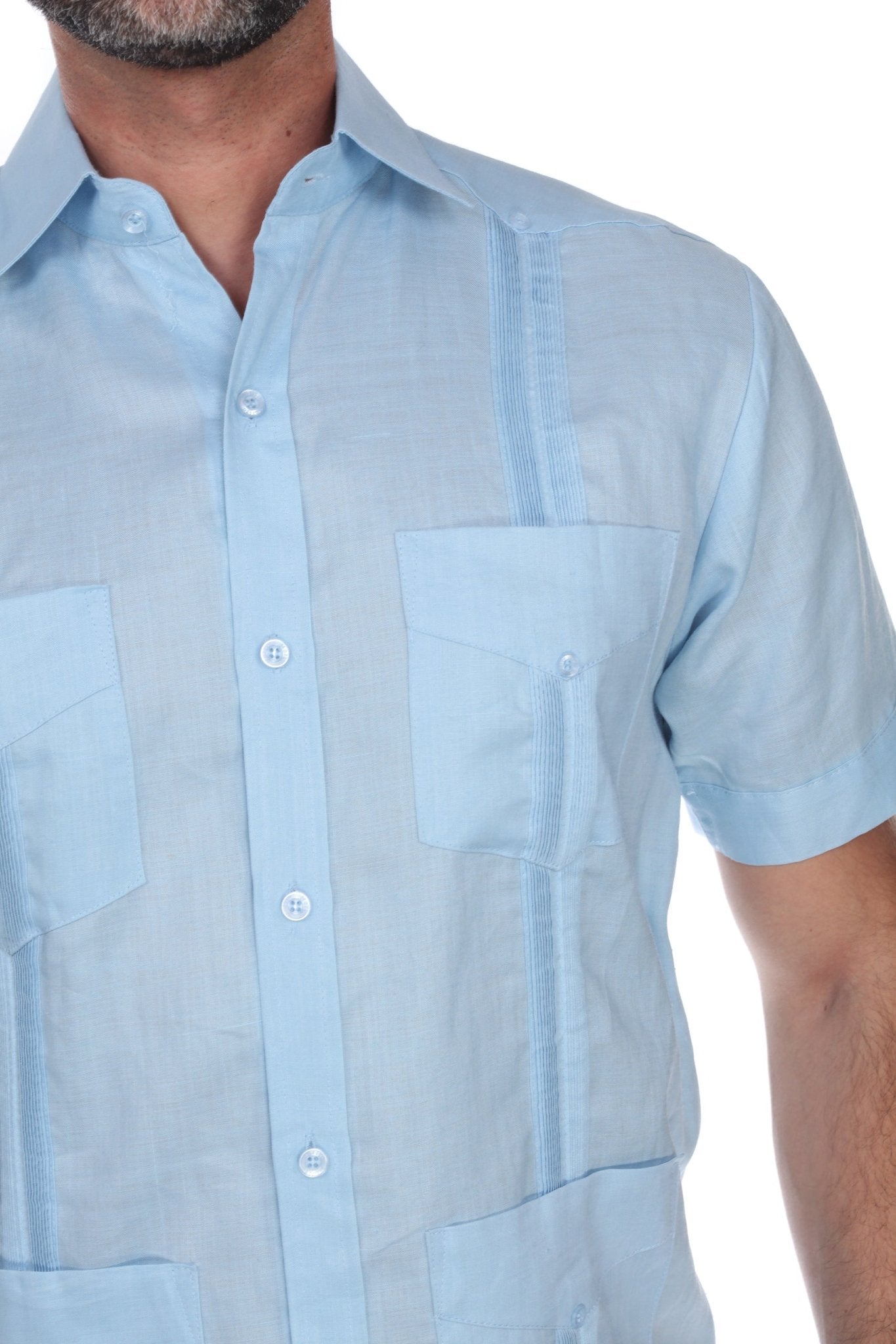 Men’s light blue short sleeve guayabera shirt featuring a traditional 4-pocket layout and breathable cotton-blend fabric.