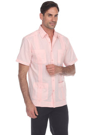 Man wearing a light pink short-sleeve shirt on a white background