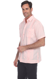 Man wearing a light pink short-sleeve shirt on a white background
