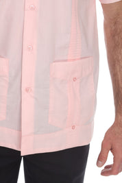 Close-up of a light pink shirt with a pocket on a white background