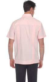 A man viewed from the back wearing a light pink short-sleeve button-up shirt with vertical sheer mesh panels on the back, paired with black trousers, against a plain white background.