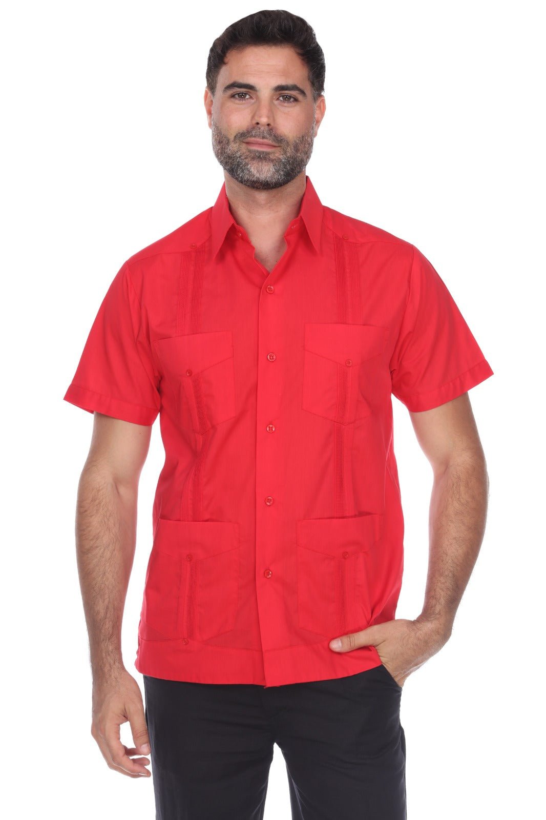 A man wearing a bright red short-sleeve button-up shirt with two chest pockets and four front patch pockets, paired with black pants, against a plain white background.