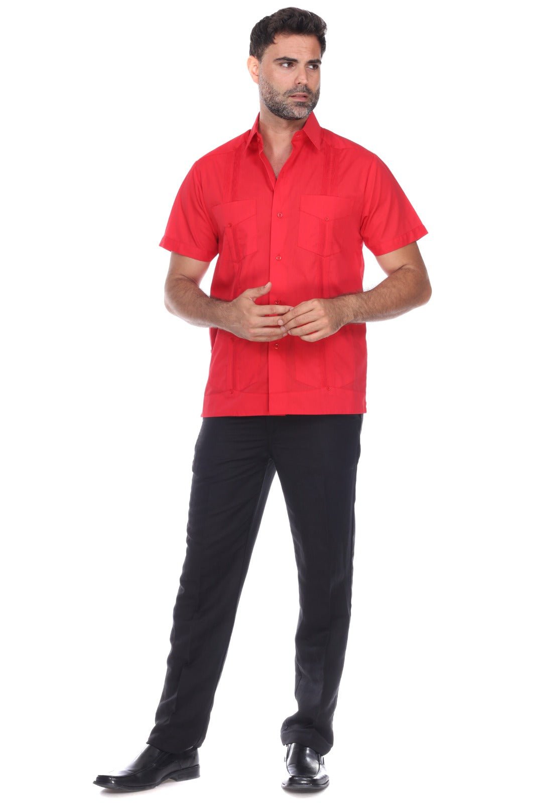 A man modeling a bright red short-sleeve button-up shirt with black trousers and black shoes, standing against a plain white background.