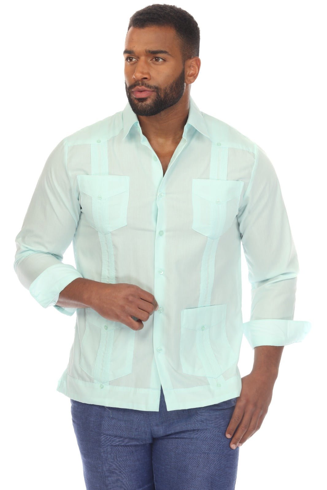 A man wearing a light mint green Guayabera-style button-up shirt with vertical mesh panels and blue jeans, photographed against a plain white background.