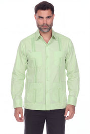 A man wearing a light green guayabera-style button-up shirt with vertical pleats and front chest pockets, paired with black pants, against a plain white background.