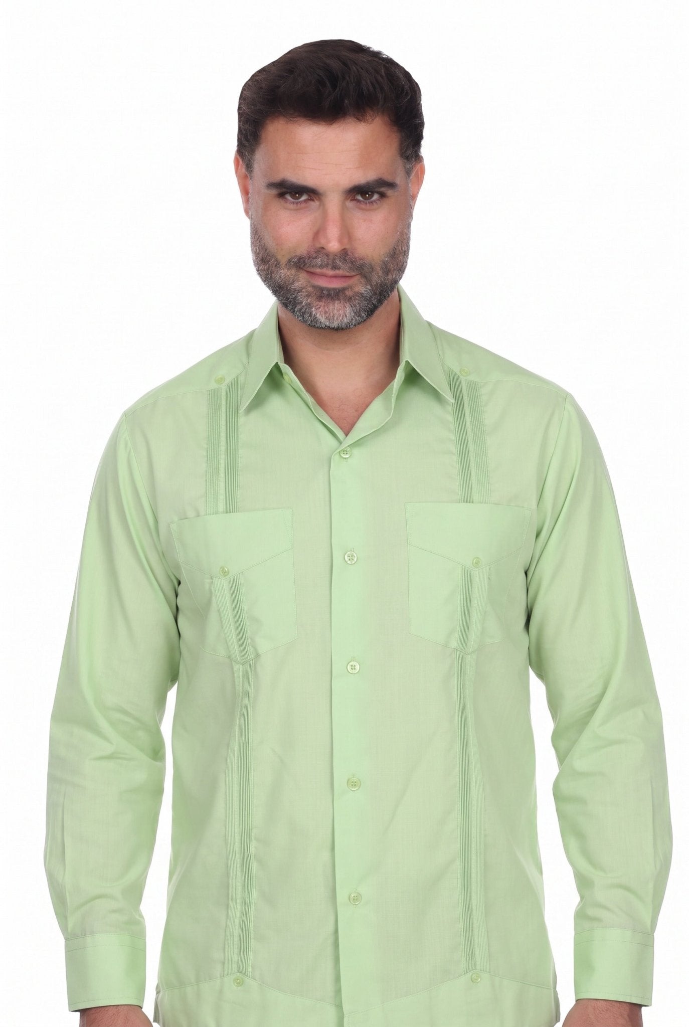 A man wearing a light green Guayabera-style button-down shirt with vertical pleats and chest pockets, photographed against a plain white background.