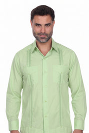 A man wearing a light green Guayabera-style button-down shirt with vertical pleats and chest pockets, photographed against a plain white background.