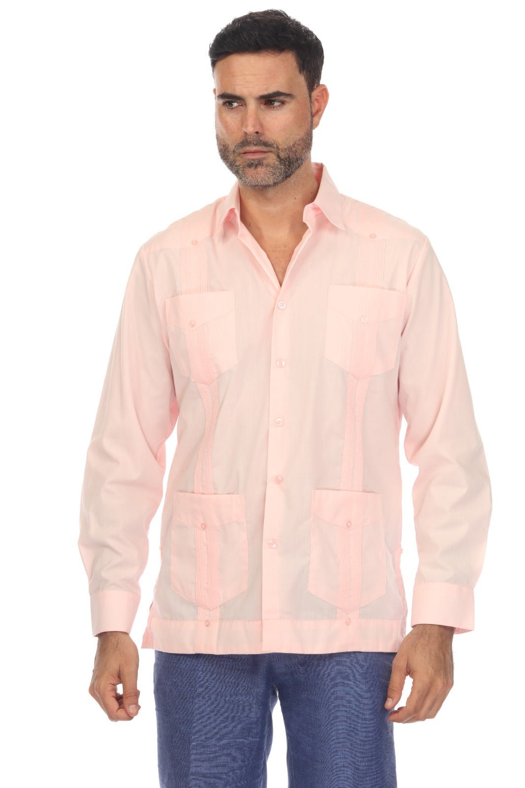 A man wearing a light pink guayabera-style button-up shirt with sheer mesh panels and blue patterned pants, photographed against a plain white background.