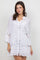 A woman models the Ladies Boho Lace Trim Blouse with Tank 3/4 Dress Set in white with button detail and lace trim flaired sleeves.
