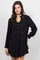 A woman models the black Ladies Boho Lace Trim Blouse with Tank Long-Sleeve Dress Set.