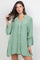 Model wearing the Ladies Boho Lace Trim Tunic Dress set, a light green mini dress with lace accents.