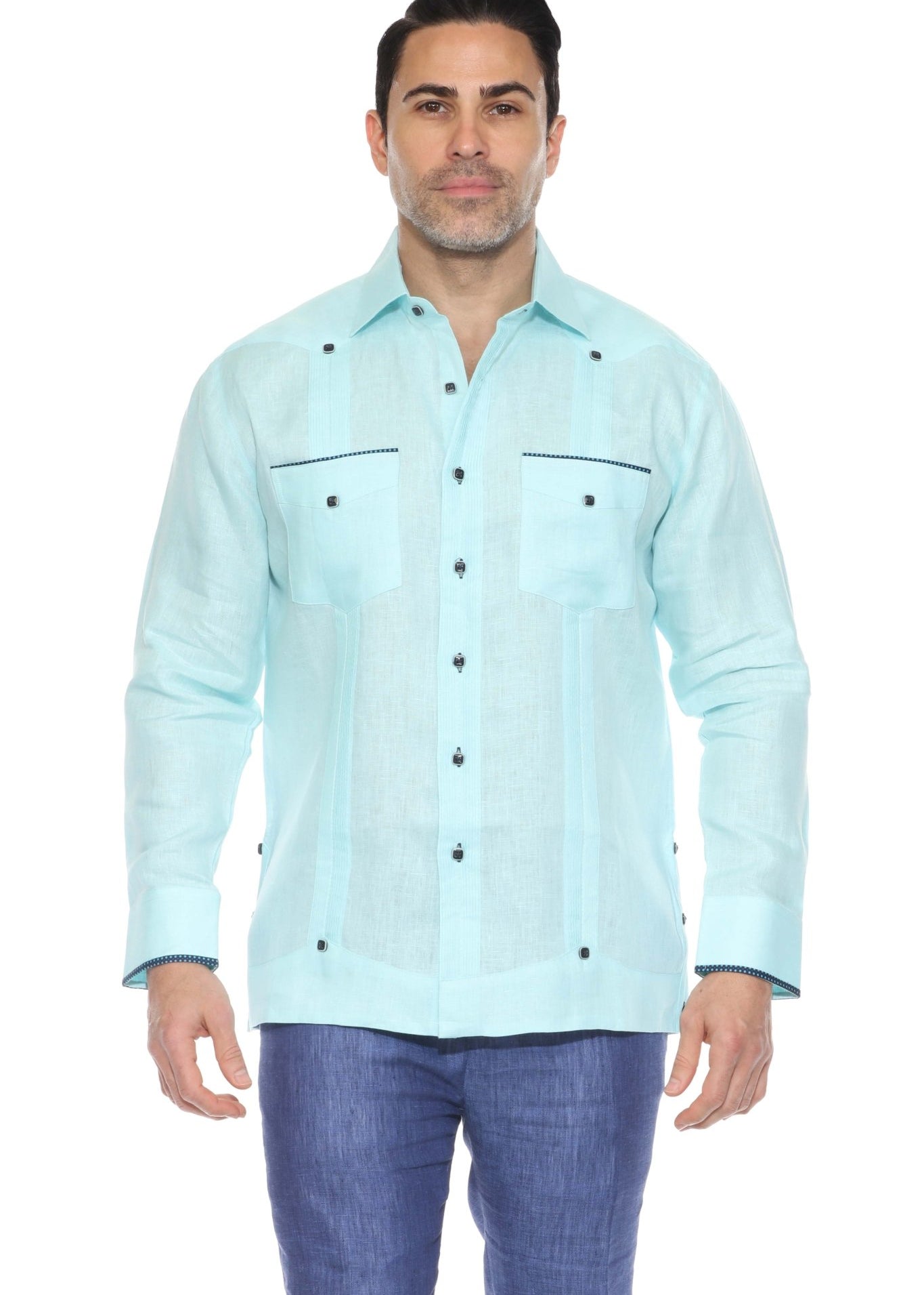 Full body studio shot of an aqua blue linen guayabera shirt styled with navy blue trousers.