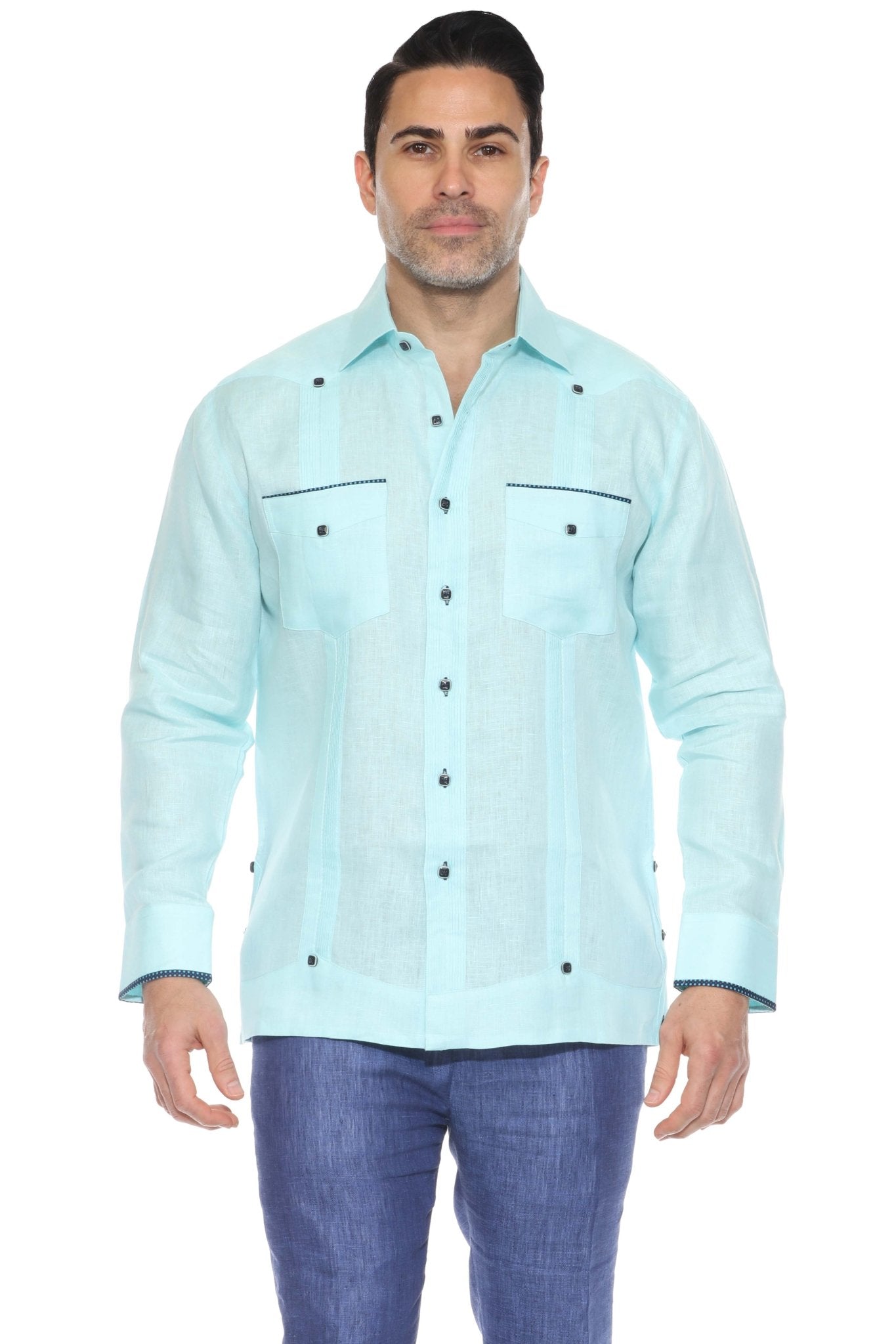 Full body studio shot of an aqua blue linen guayabera shirt styled with navy blue trousers.