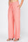 Model wearing peach Ladies Smocked Waist Drawstring Palazzo Pants, shown with hand in pocket.